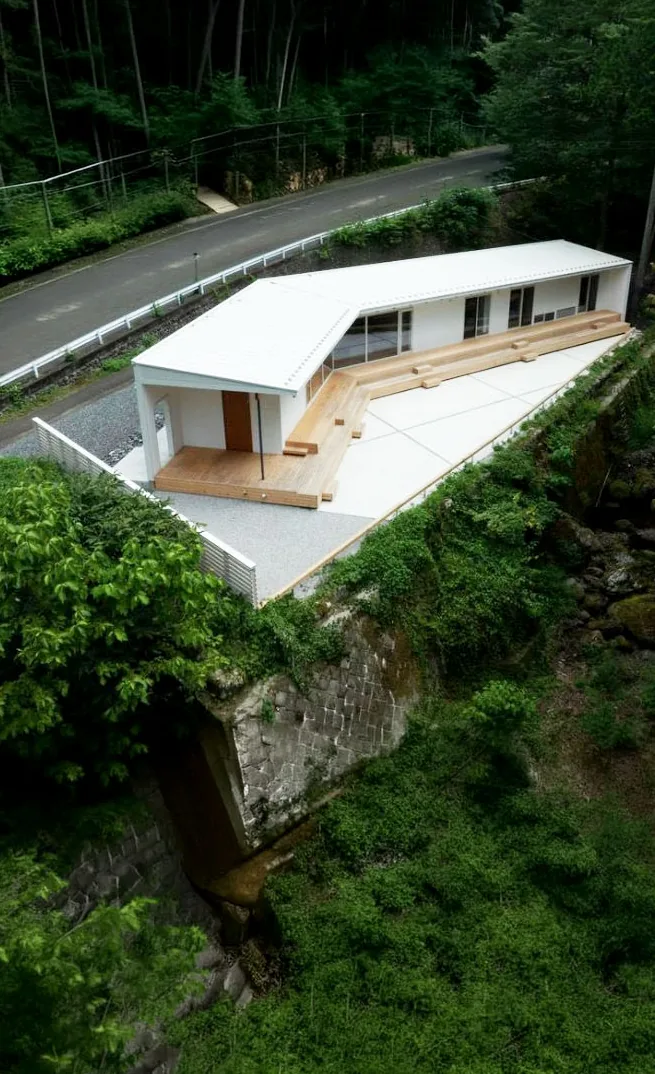奥多摩の渓流沿いに建つ HOUSE IN UNAZAWA の外観（空撮）
